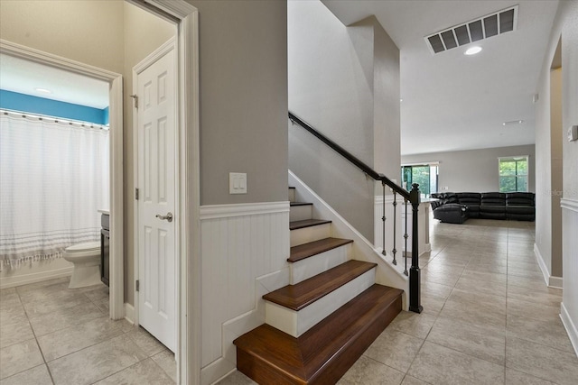 staircase featuring tile patterned flooring