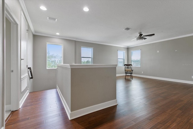 interior space featuring a textured ceiling, ceiling fan, dark hardwood / wood-style floors, and ornamental molding