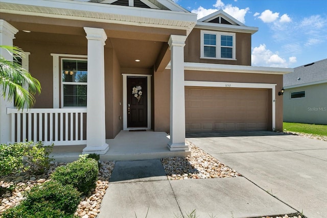 view of front of home featuring covered porch and a garage