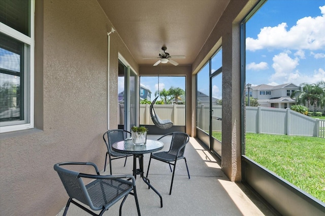 sunroom with ceiling fan