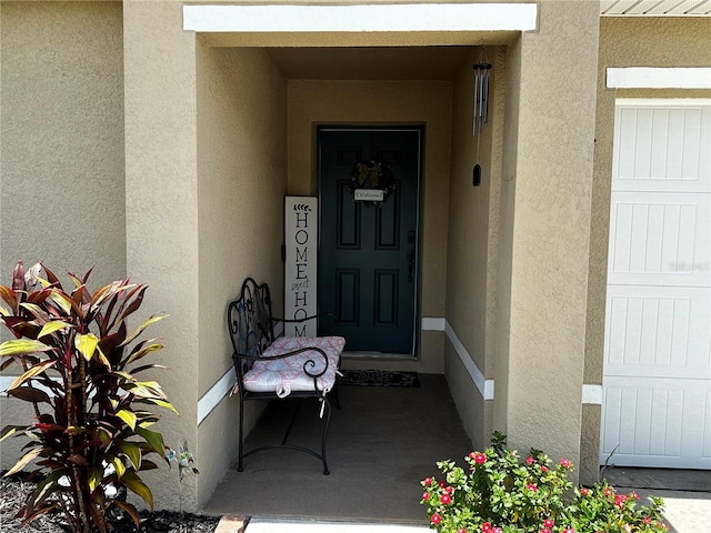 view of exterior entry with a garage