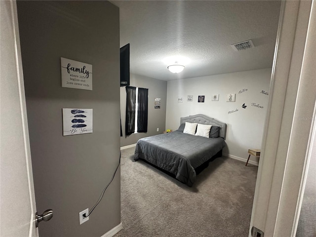 carpeted bedroom featuring a textured ceiling