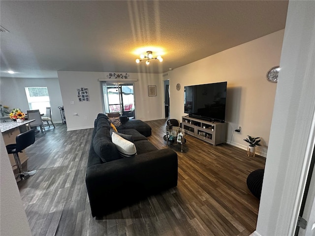 living room with dark hardwood / wood-style floors and a textured ceiling