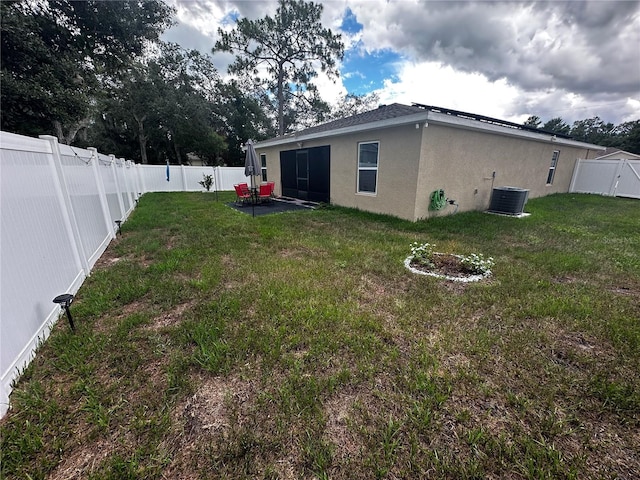 view of yard featuring central AC and a patio area