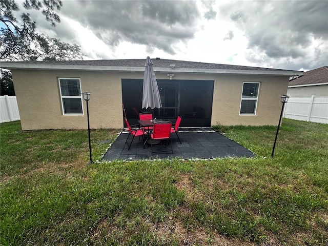 rear view of property with a patio area and a yard