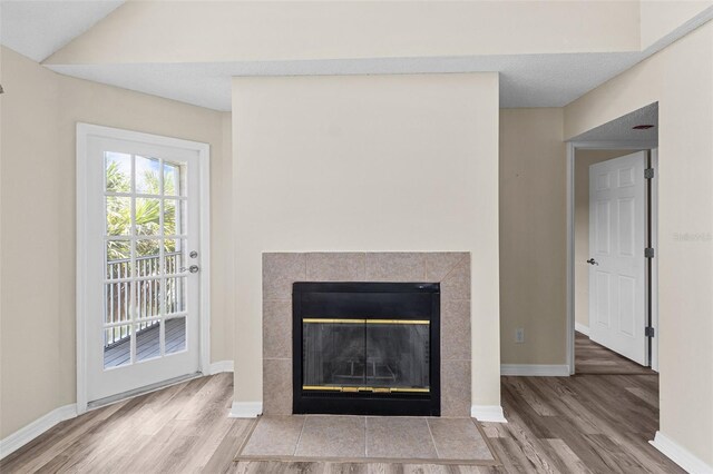 room details featuring hardwood / wood-style flooring and a tile fireplace