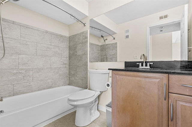 full bathroom featuring toilet, tiled shower / bath combo, tile patterned floors, and vanity