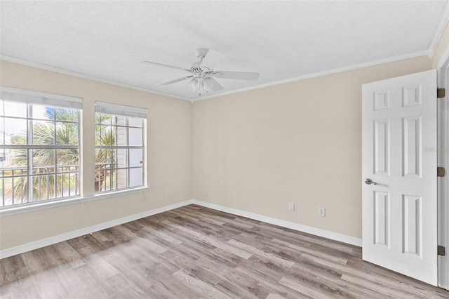 spare room with a textured ceiling, ceiling fan, crown molding, and light hardwood / wood-style flooring