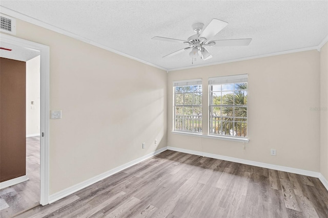 spare room with ceiling fan, ornamental molding, a textured ceiling, and light hardwood / wood-style floors