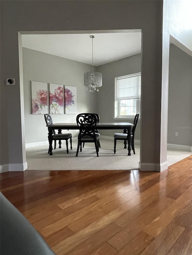 dining room featuring wood-type flooring and a chandelier