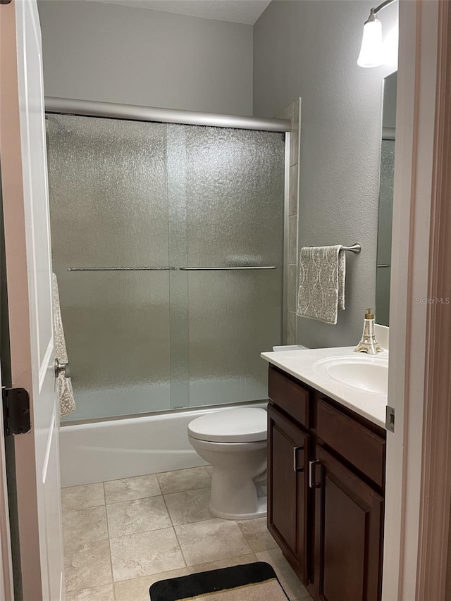 full bathroom featuring enclosed tub / shower combo, vanity, and toilet