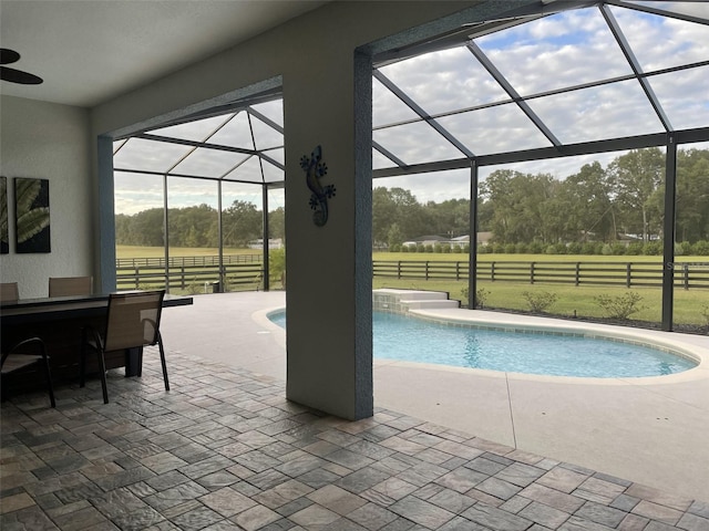 view of pool featuring a lanai, an outdoor bar, and a patio area