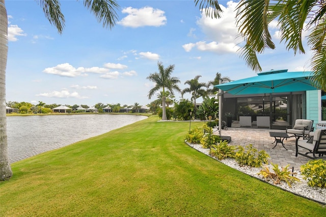 view of yard featuring a water view and a patio