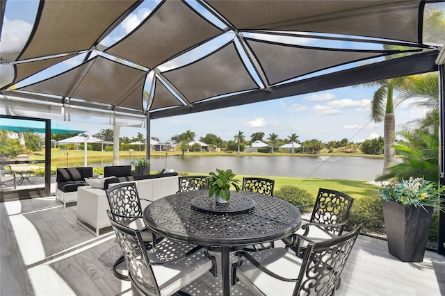 wooden deck featuring a lawn and a water view