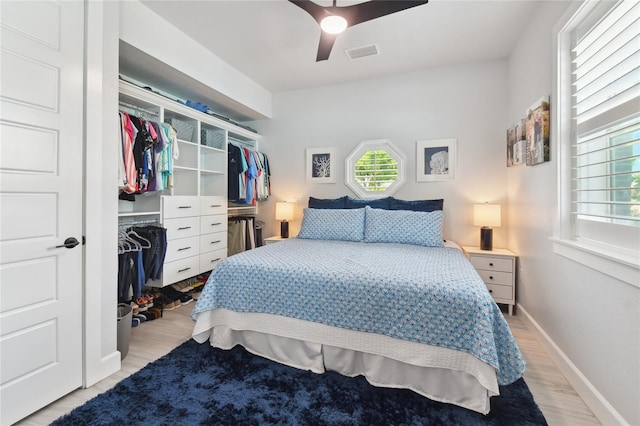 bedroom featuring ceiling fan, a closet, and light hardwood / wood-style floors