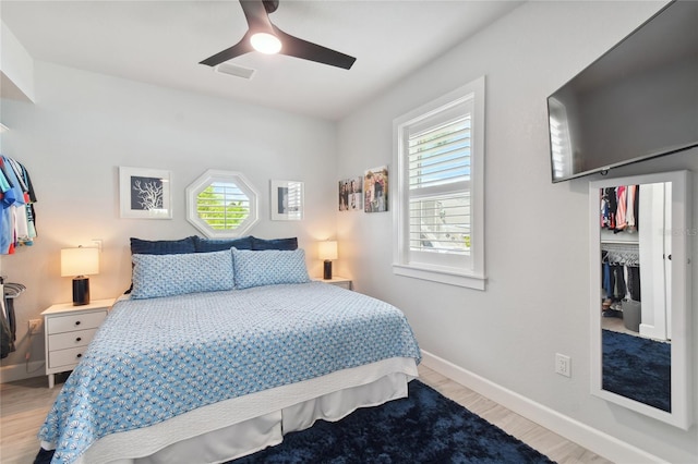 bedroom featuring ceiling fan, light wood-type flooring, and a closet