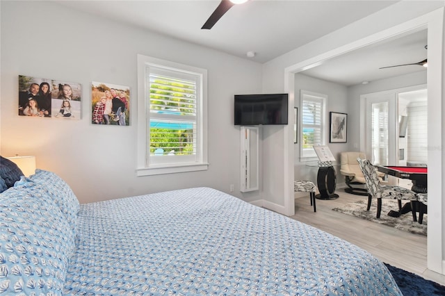 bedroom with ceiling fan and hardwood / wood-style floors