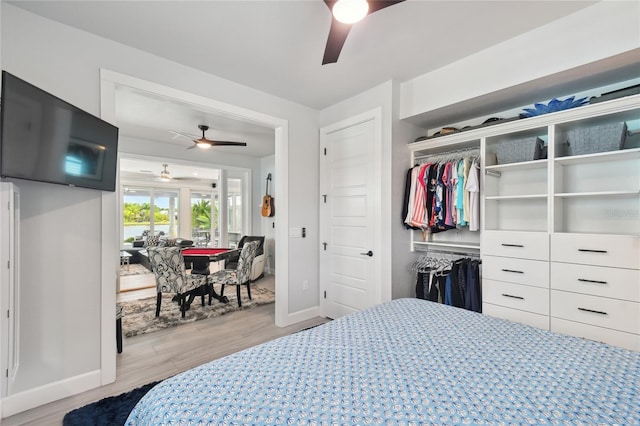 bedroom featuring a closet, light hardwood / wood-style flooring, and ceiling fan