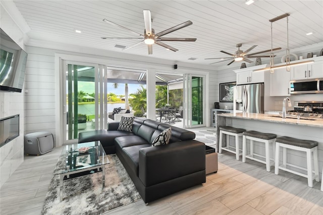 living room with sink, wood ceiling, and ornamental molding