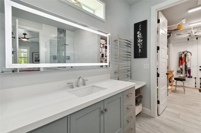 bathroom featuring walk in shower, vanity, ceiling fan, and a healthy amount of sunlight