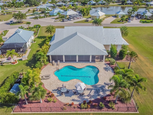 view of pool with a water view and a patio