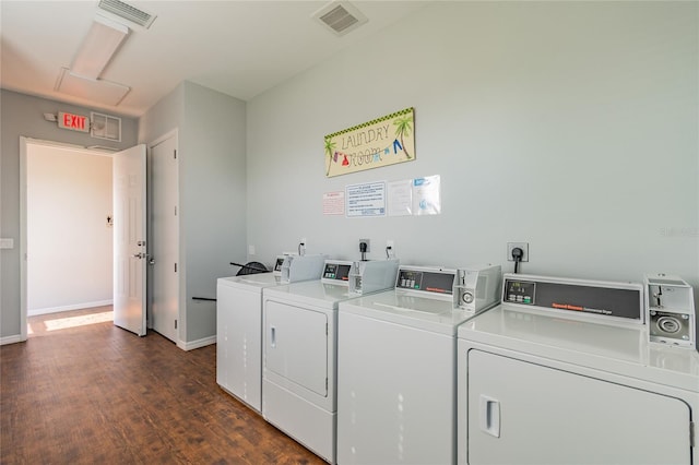 washroom with washing machine and dryer and dark hardwood / wood-style floors