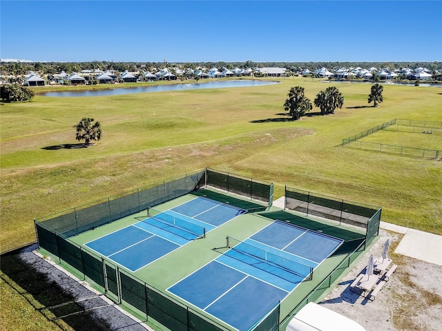 view of sport court with a water view