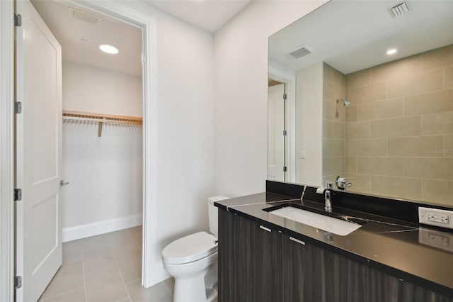 bathroom featuring toilet, vanity, and tile patterned floors