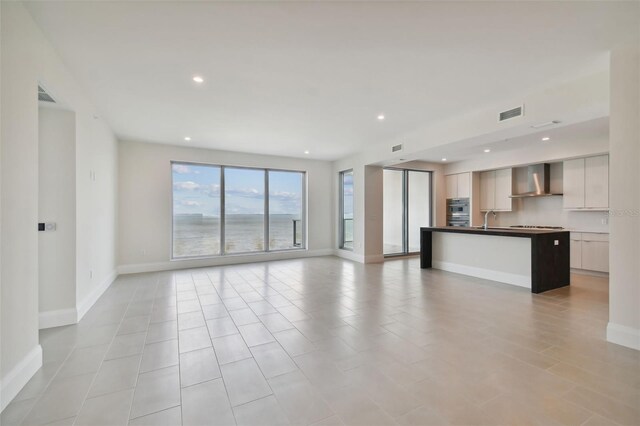 unfurnished living room with sink