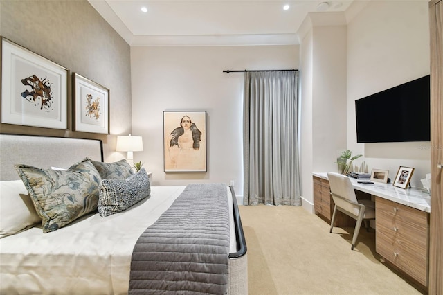 bedroom with crown molding, built in desk, and light carpet