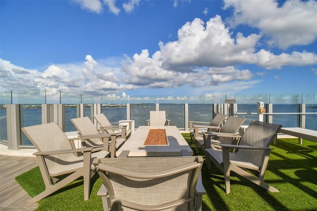 view of patio featuring a water view and an outdoor fire pit