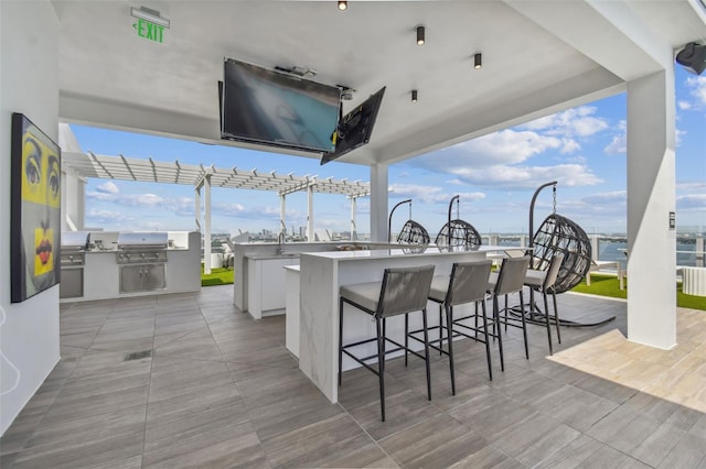 view of patio / terrace featuring an outdoor bar and grilling area