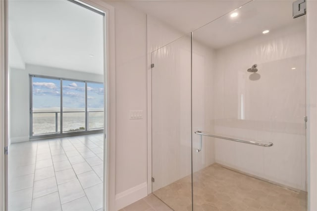 bathroom with tile patterned flooring and a shower with shower door