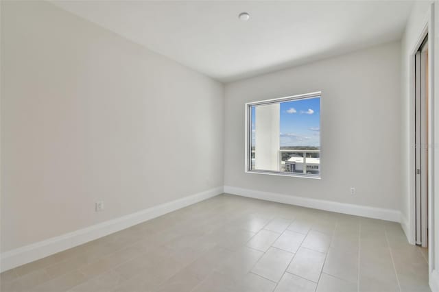 empty room with light tile patterned flooring