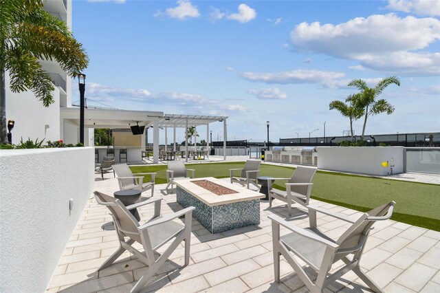 view of patio / terrace with a bar and a fire pit