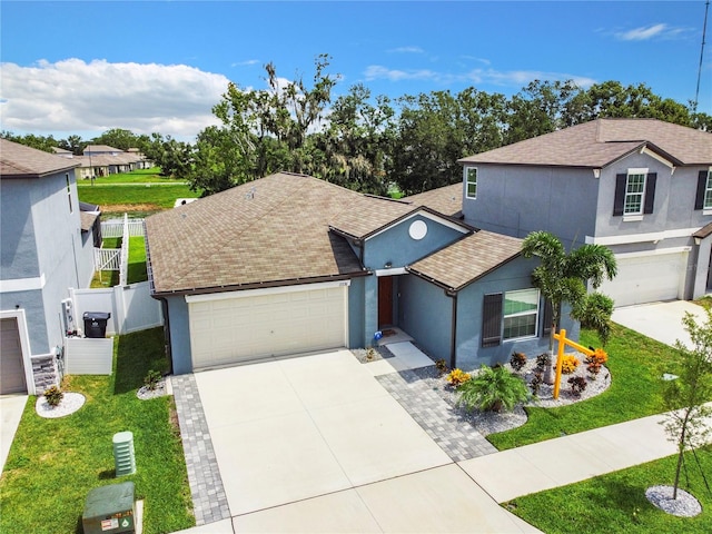 view of front of house featuring a garage and a front lawn