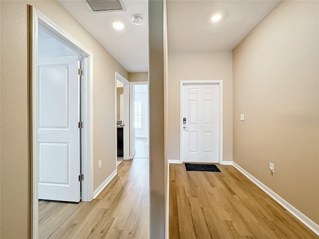 corridor featuring light hardwood / wood-style floors