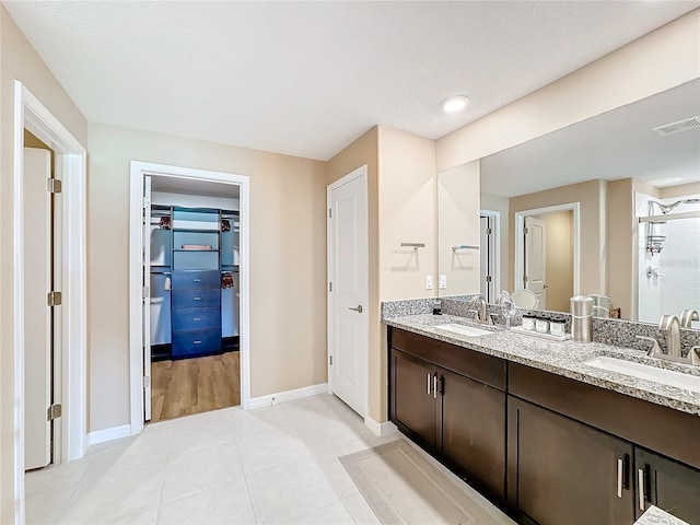 bathroom featuring vanity, tile patterned floors, and a shower with shower door