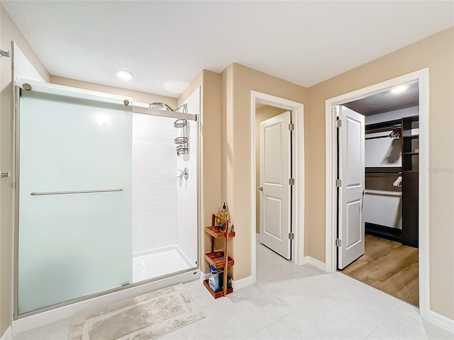 bathroom with tile patterned floors and a shower with shower door