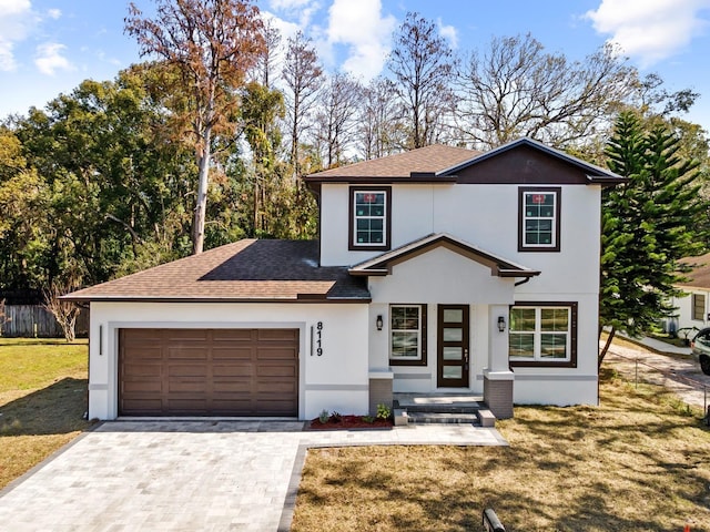 view of front property with a garage and a front yard