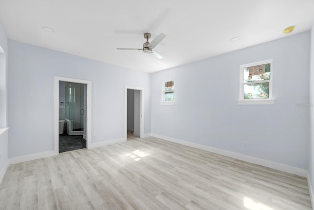 unfurnished bedroom featuring ceiling fan, light wood-type flooring, and ensuite bath