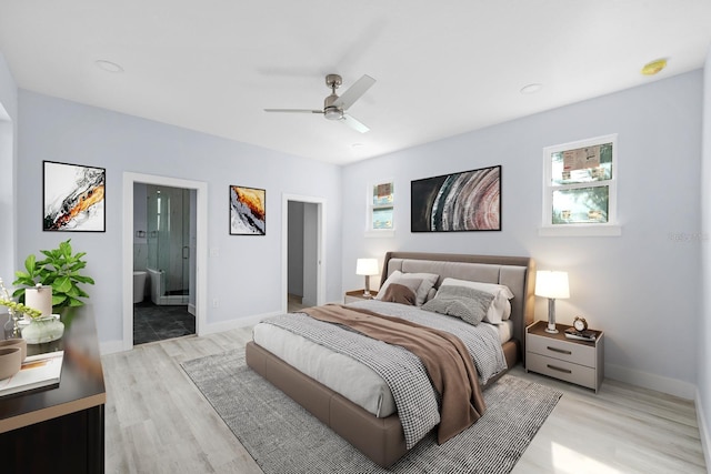 bedroom with ensuite bathroom, ceiling fan, and light wood-type flooring