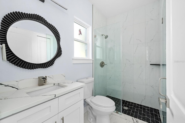 bathroom featuring vanity, an enclosed shower, and toilet