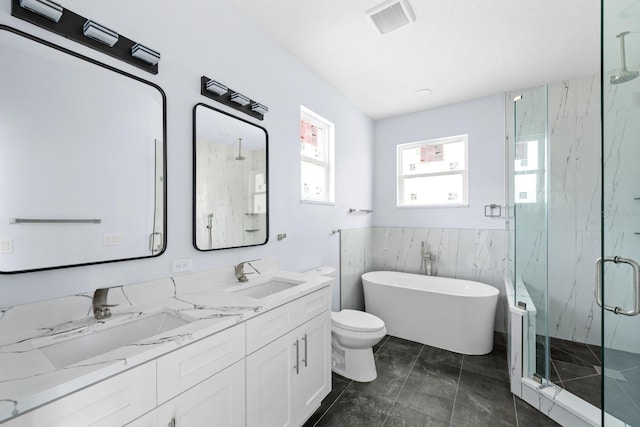 full bathroom with toilet, vanity, plus walk in shower, and tile walls