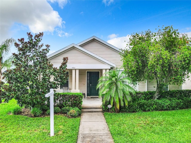 bungalow-style home featuring a front yard