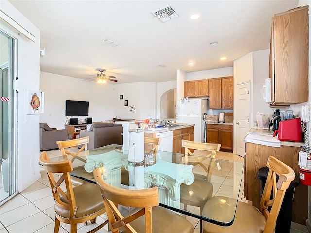 tiled dining area featuring sink and ceiling fan