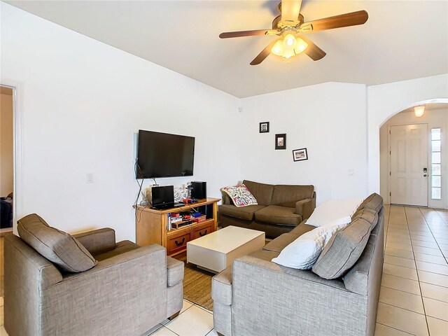 tiled living room with ceiling fan