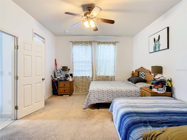 carpeted bedroom featuring multiple windows and ceiling fan