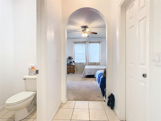 bathroom featuring toilet, tile patterned flooring, and ceiling fan