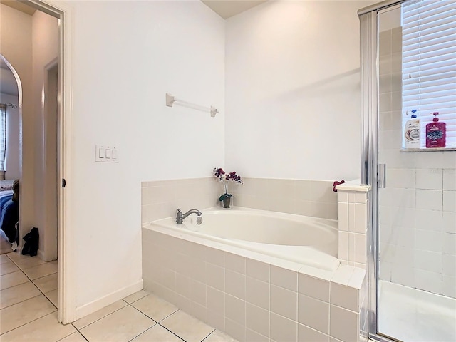 bathroom featuring tile patterned flooring and independent shower and bath